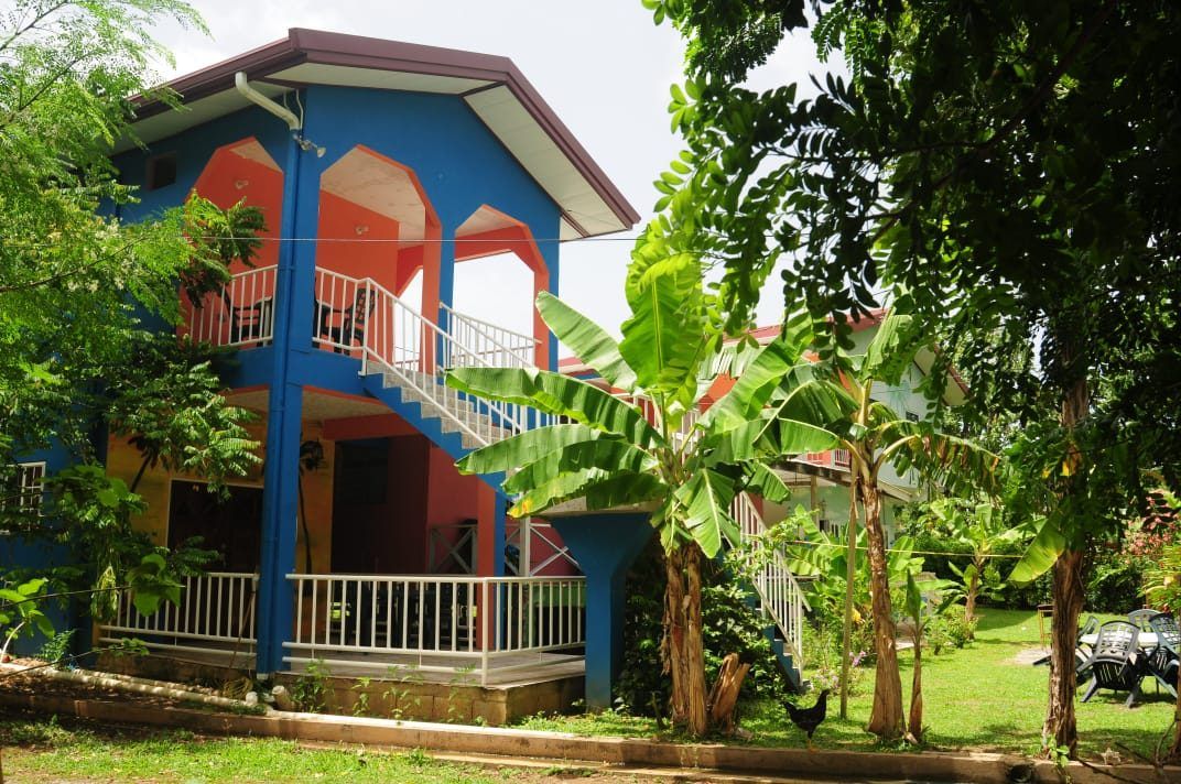 The blue and orange guest house building from the garden