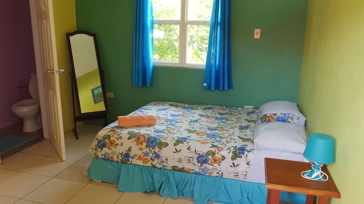 Rainforest's queen bed, with its own bathroom through the door