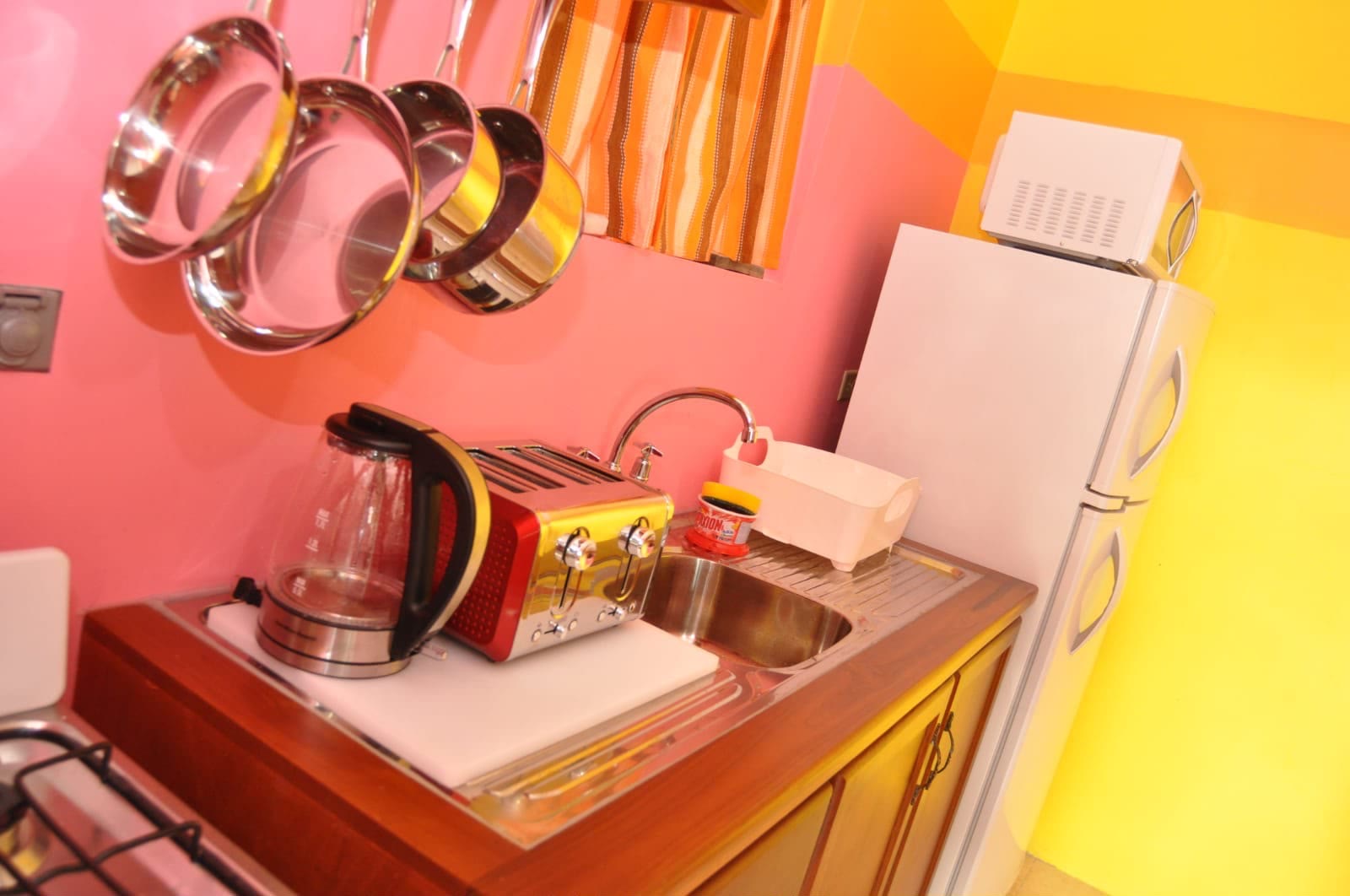 The unit's own kitchen corner, with kettle, toaster and fridge