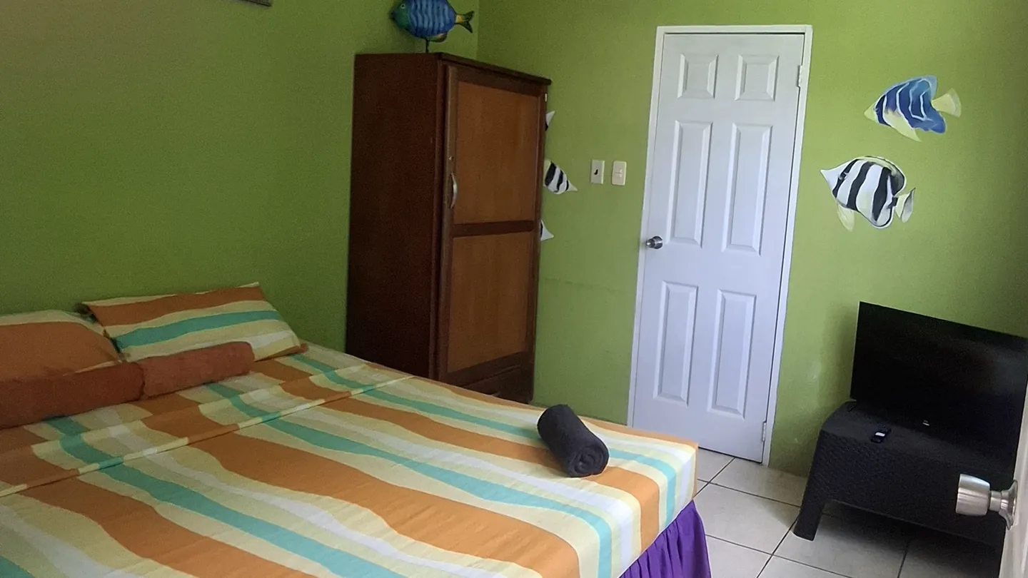 Nylon Pool's private sleeping section, a queen bed, wardrobe and television